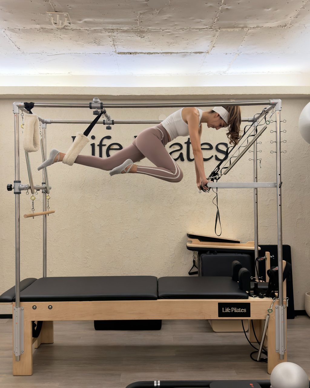 A member suspended in the Cadillac frame at Life Pilates