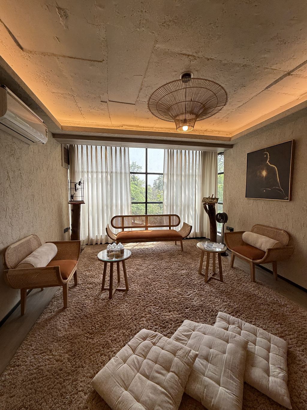 The Life Pilates lounge, with cane seating and afternoon light through tall curtains