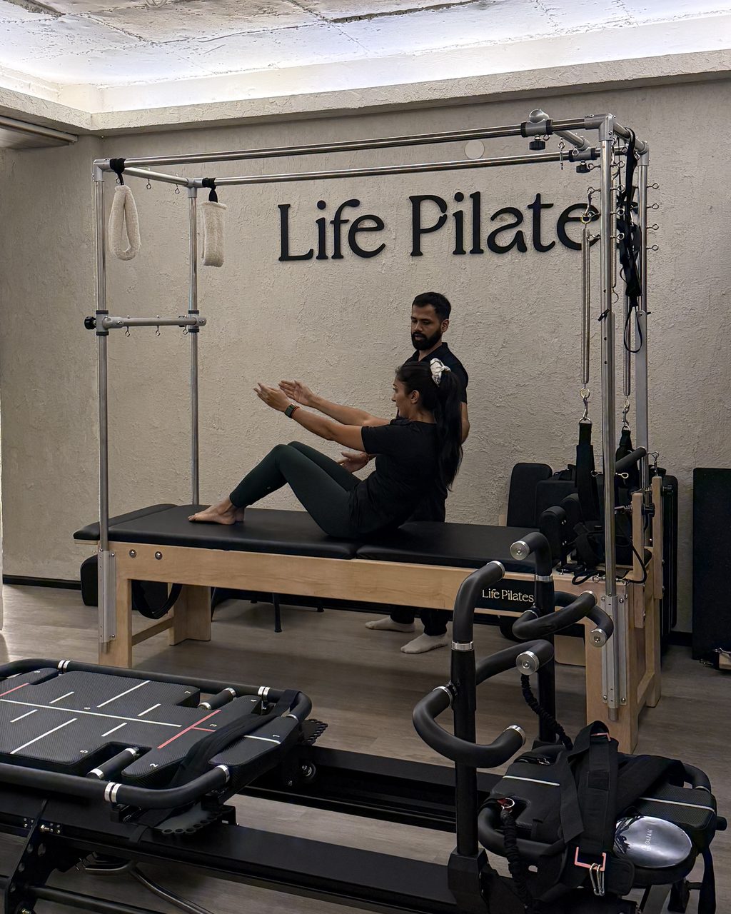 A one-to-one session on the Cadillac at Life Pilates, guided by a practitioner